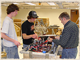 Mr. Hodapp works with Kevin Morris and Jason Maxwell on the robot