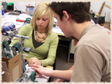 Kayleigh Cooper and Austin Lambert work on the Vex robot.